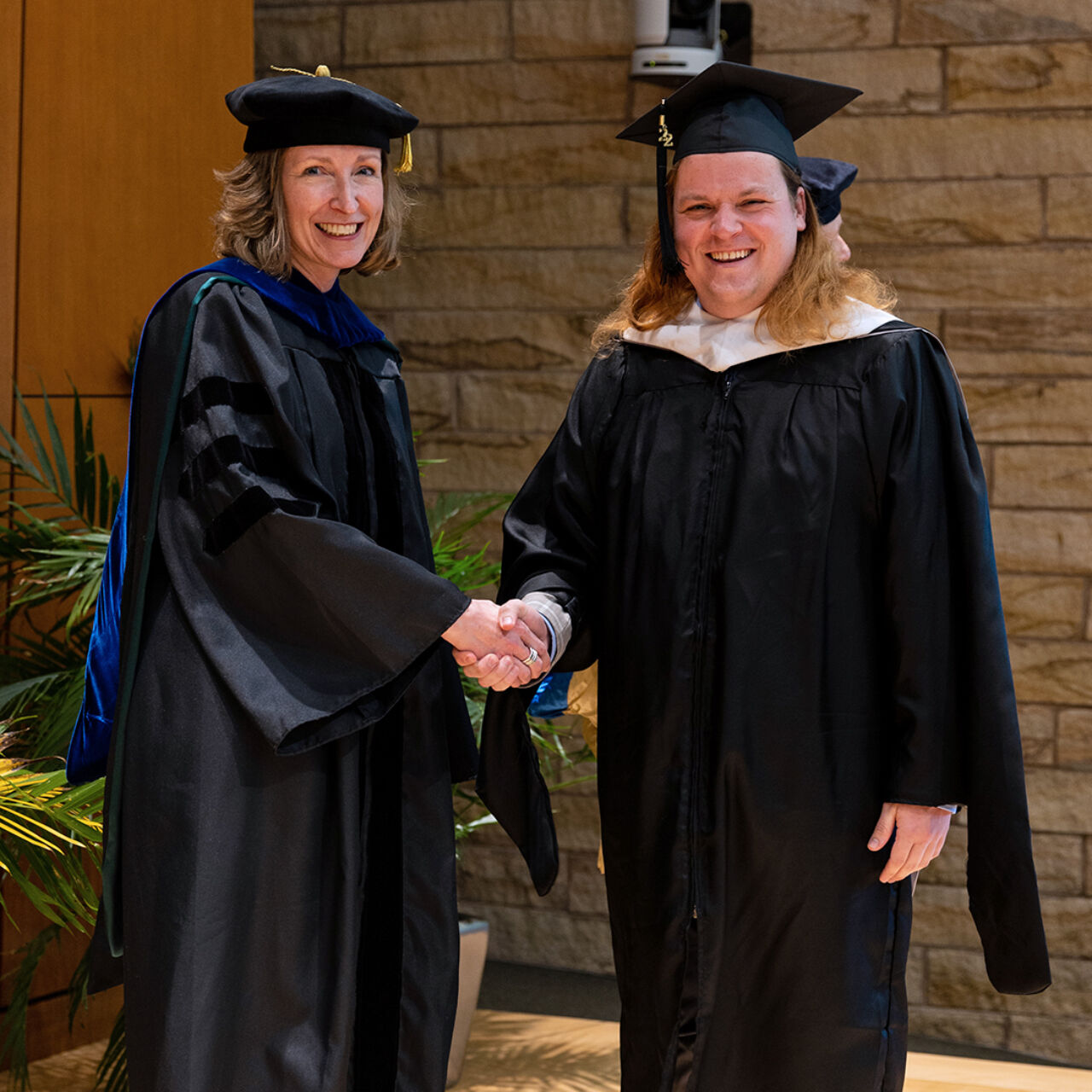 SIA Interim Director Elizabeth Ransom (left) and Class of 2022 graduate Adam VanGorder.