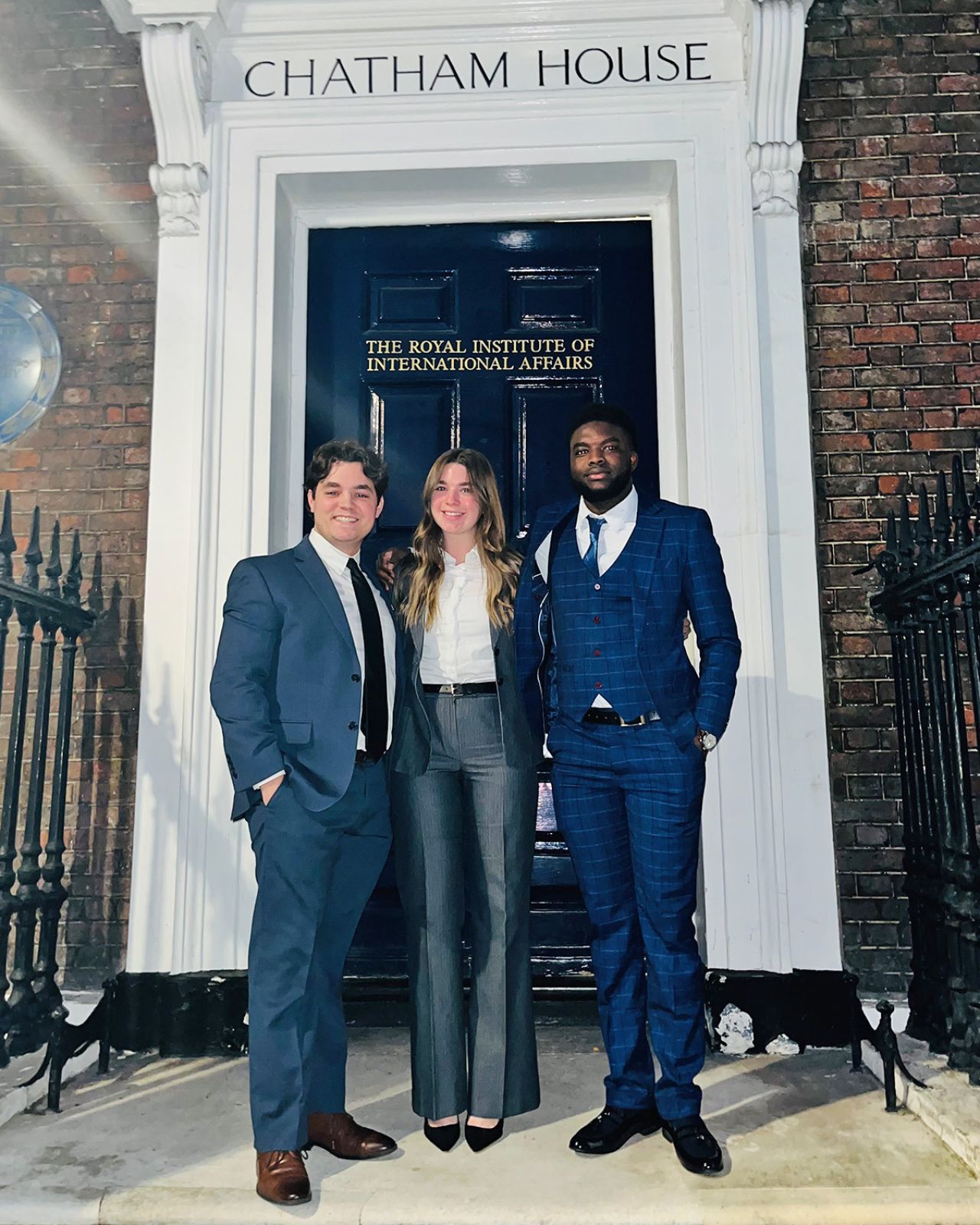 Decuir, Rios, and Mama Amadou outside Chatham House in London.